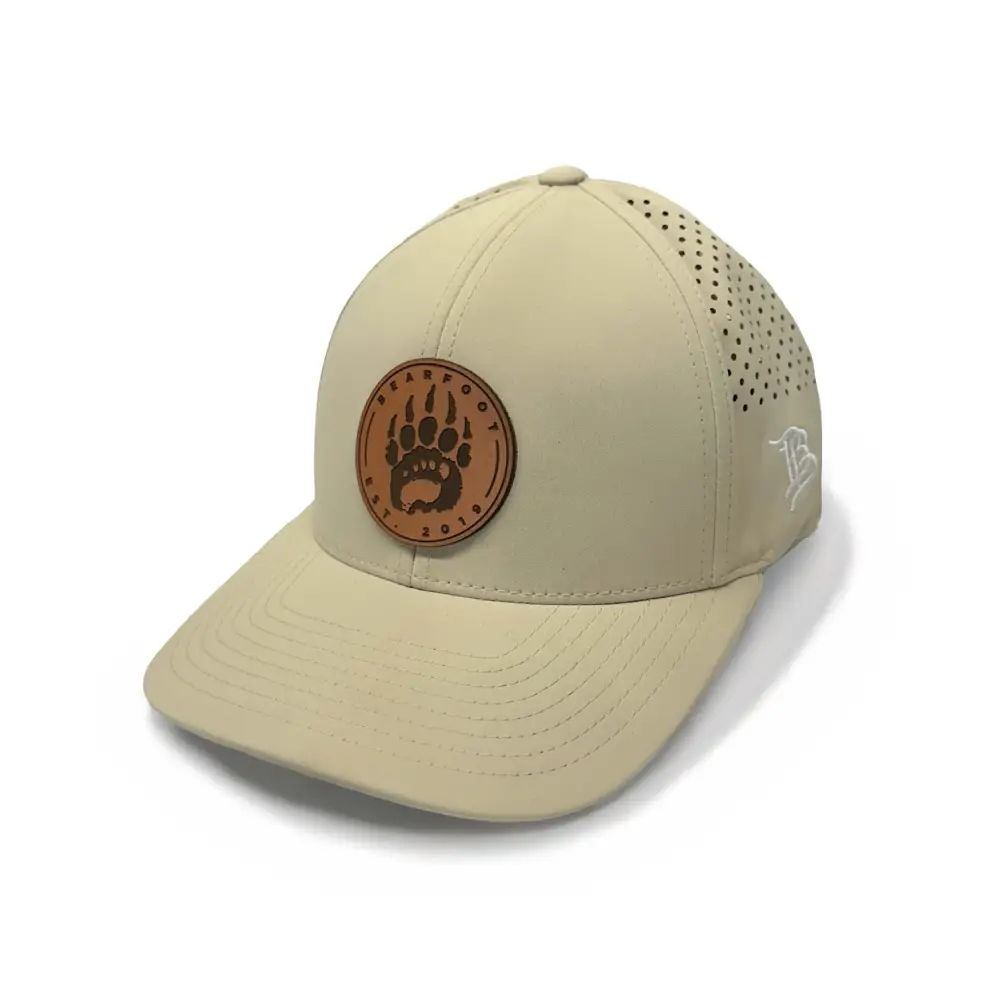 Tan leather performance cap with bear paw patch and ventilation