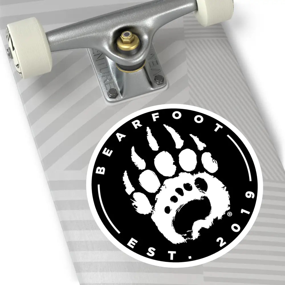 Black and white round stickers with a stylized bear paw print and protective laminate in a round shape design