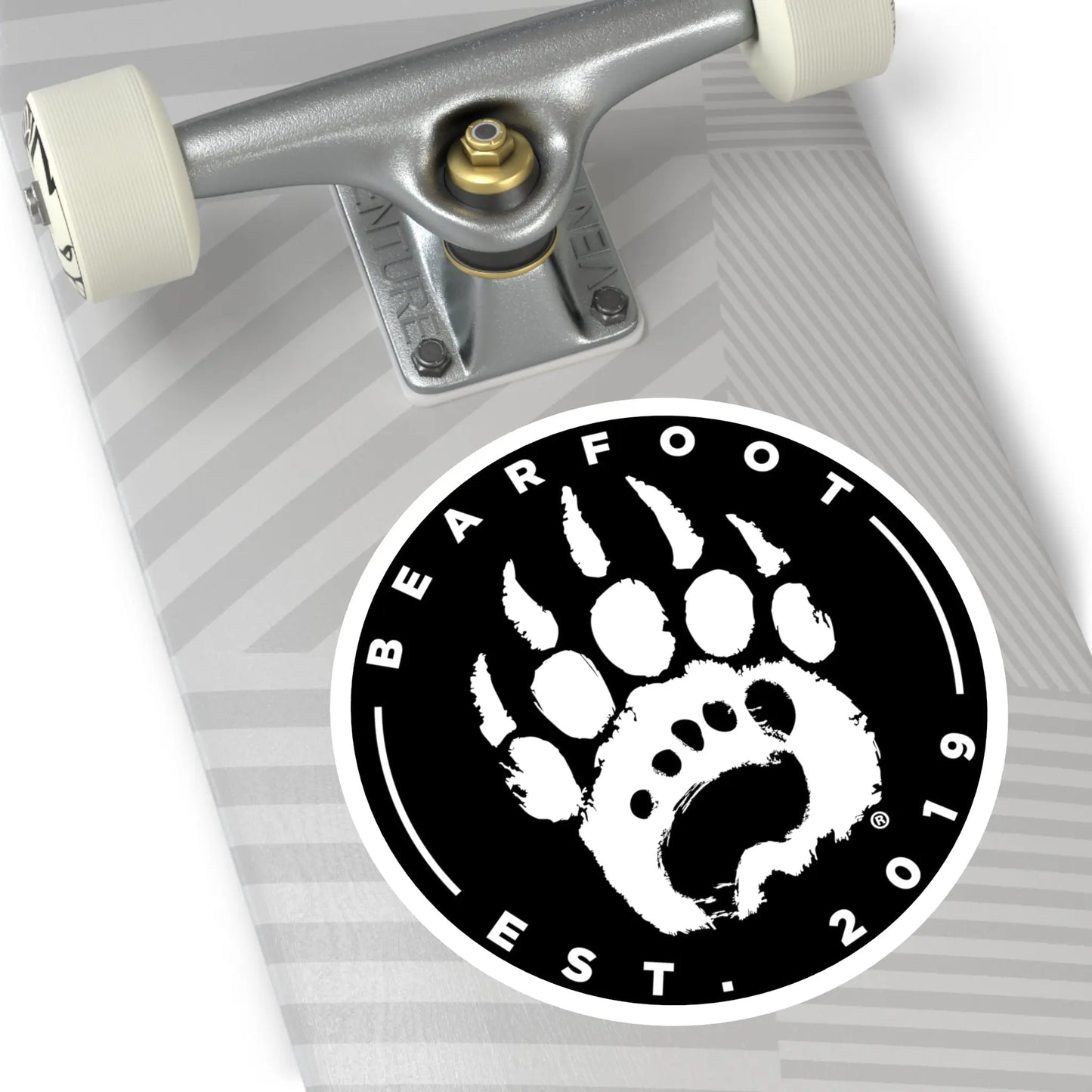 Black and white round stickers with a stylized bear paw print and protective laminate in a round shape design