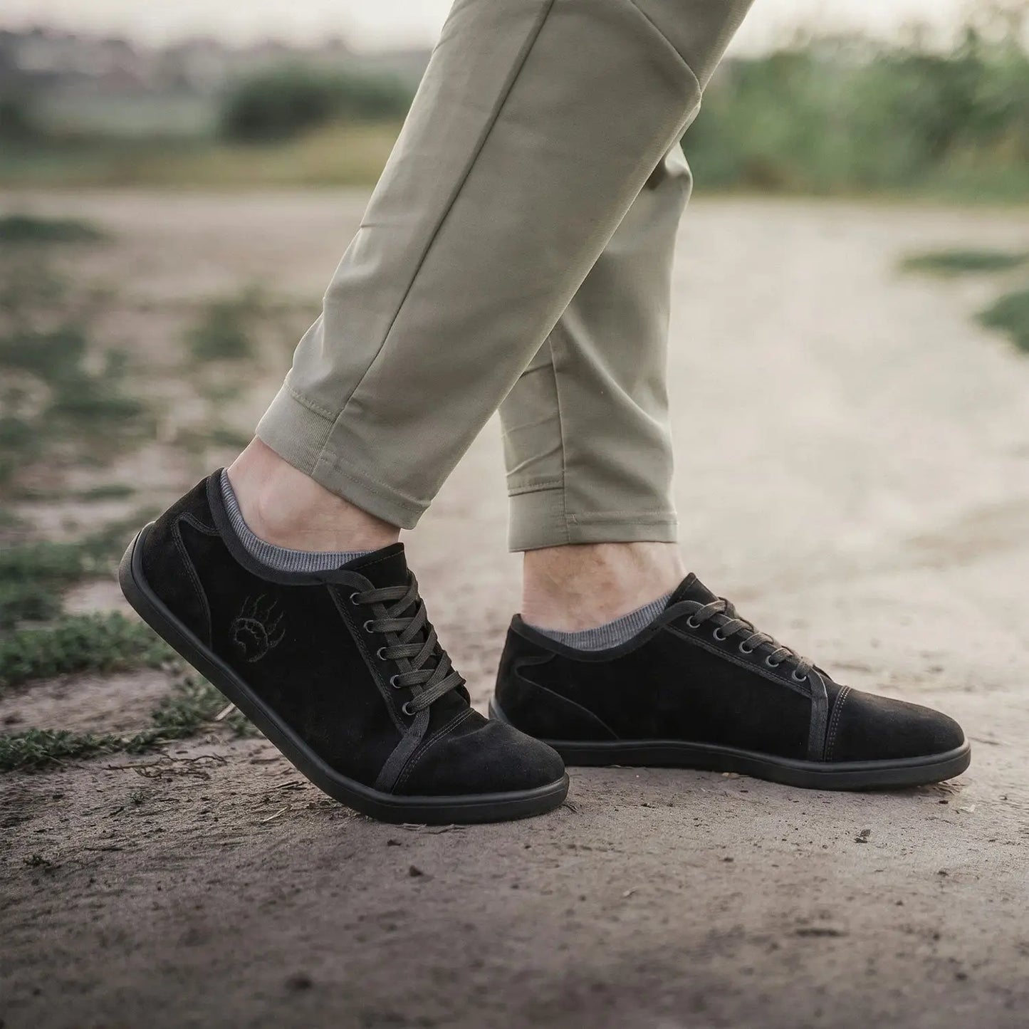 Ursus SLTG2 black suede low-top barefoot shoe with dark laces and subtle embroidered logo for natural toe splay
