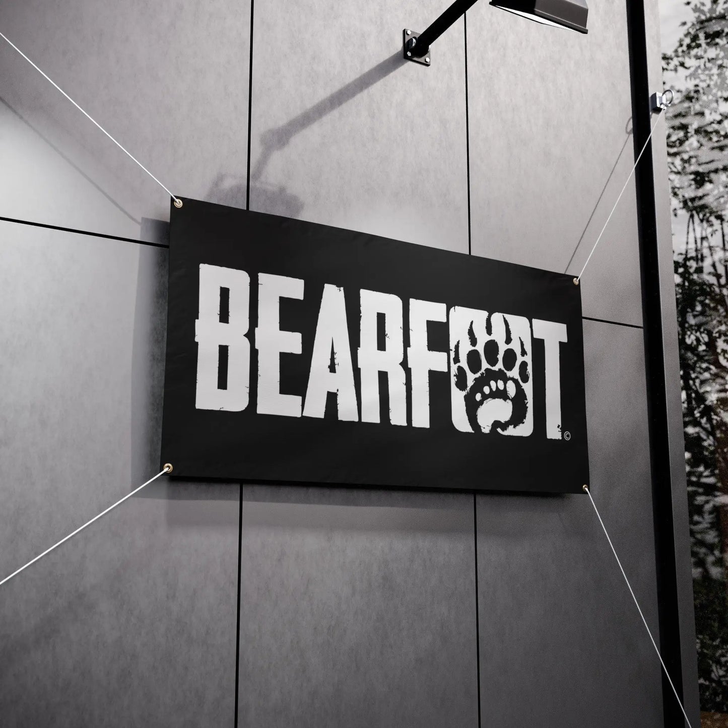 Black vinyl banner with white distressed bearfoot banner lettering and paw print logo for barefoot shoes promotion
