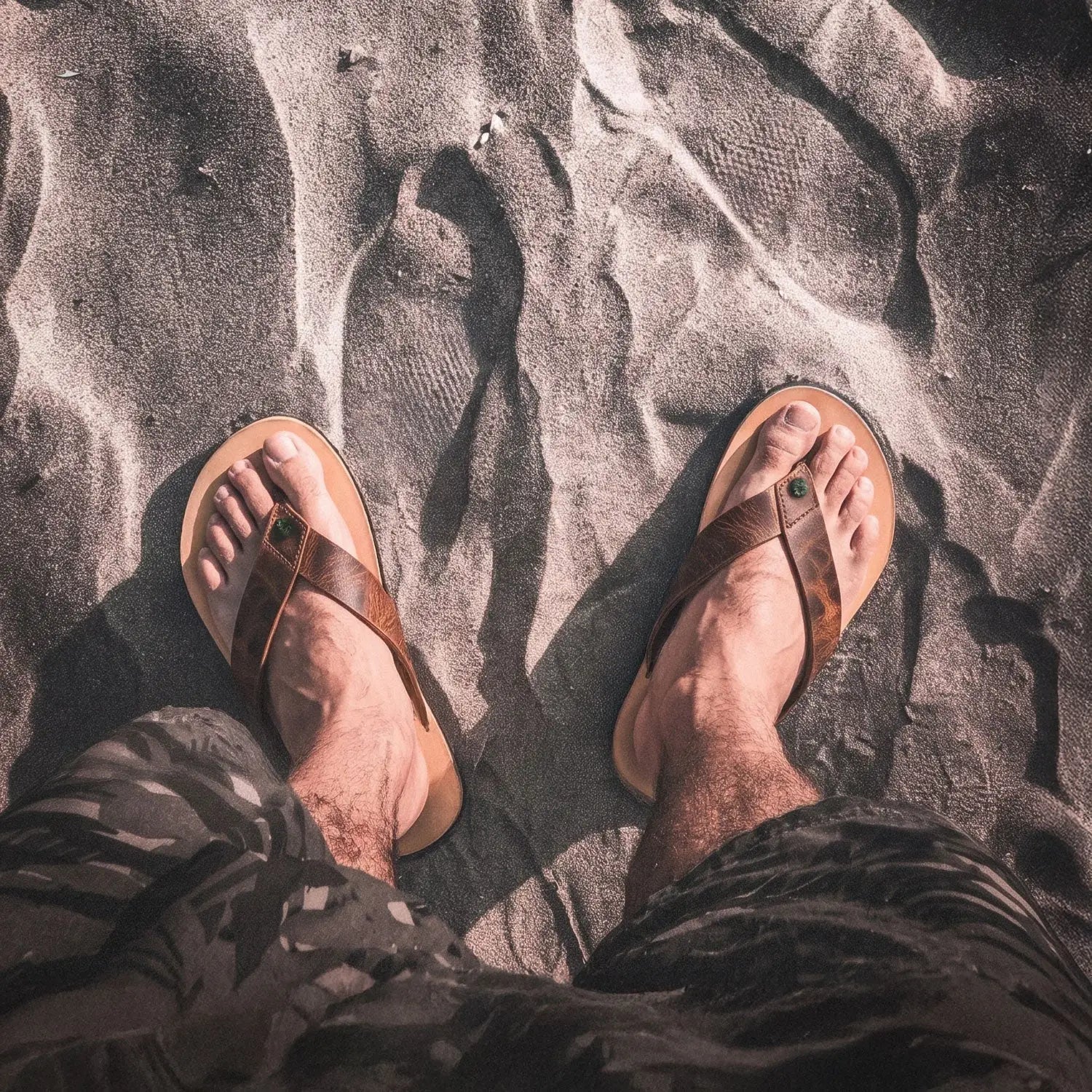 Brown bison leather bear-flops cognac flip-flops with green gemstone accent and zero-drop sole