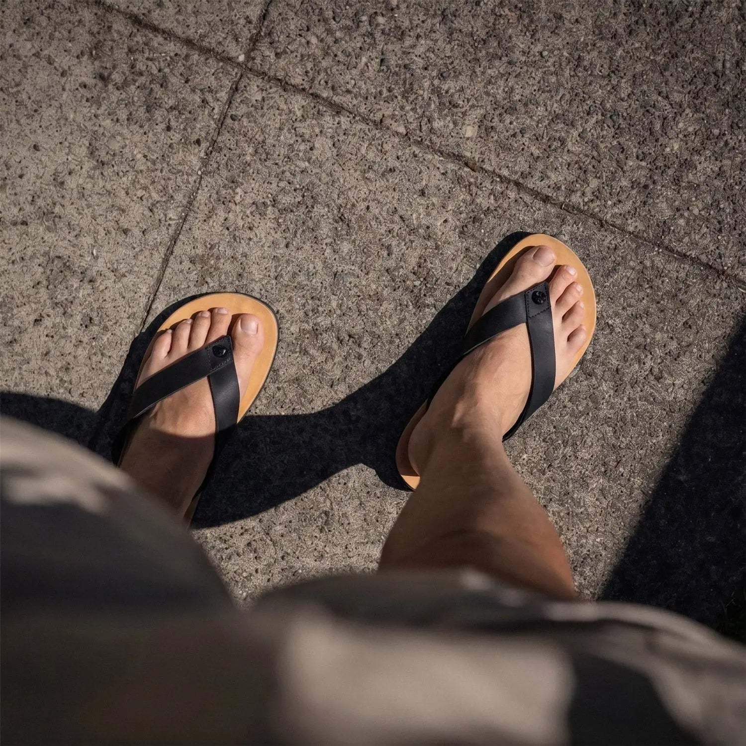 Black leather strap bear-flops dark horse flip-flops with tan rubber soles made from crazy horse leather barefoot sandals style