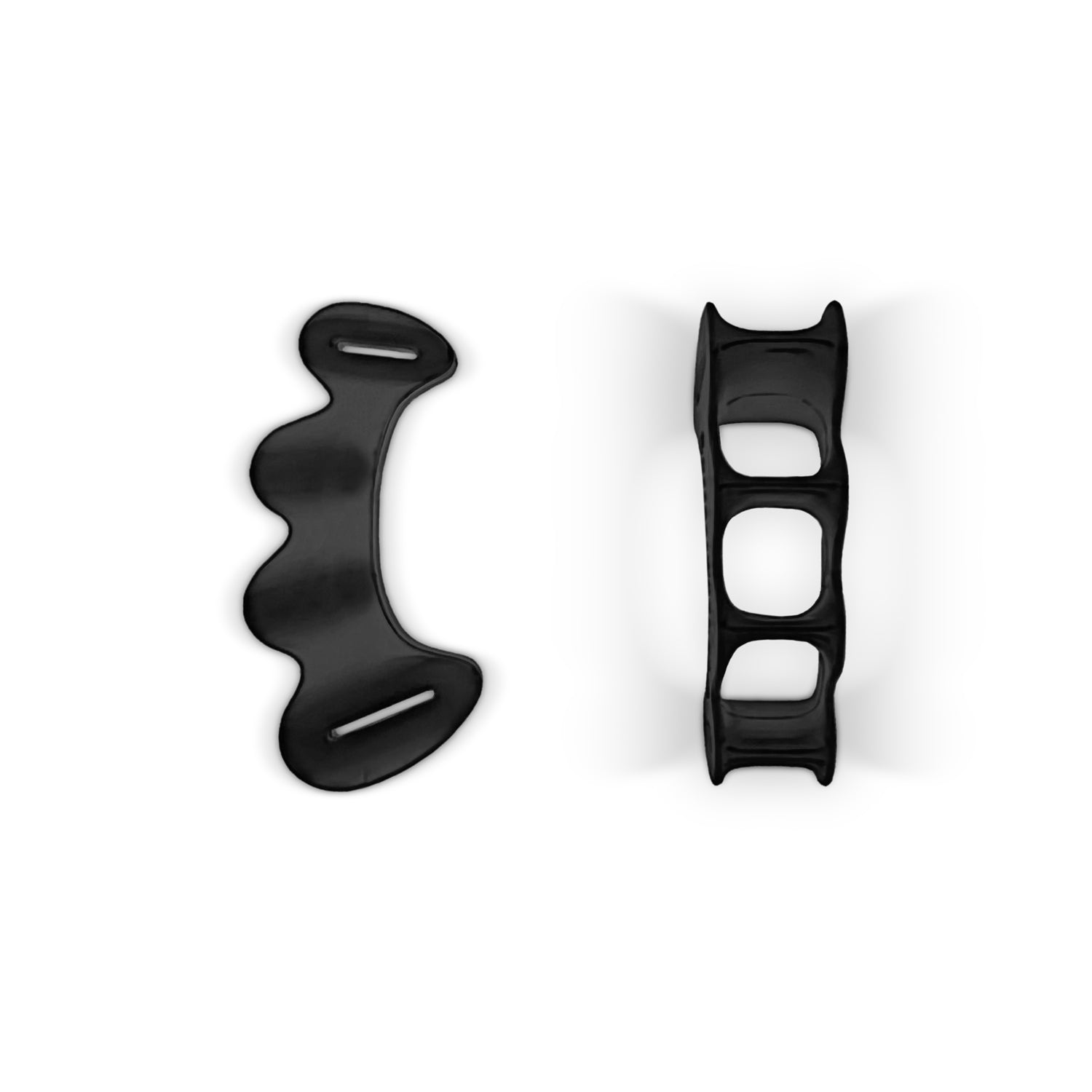Two black silicon toe spacers, one shown from the top and the other from the side, are components of Bearfoot shoes.