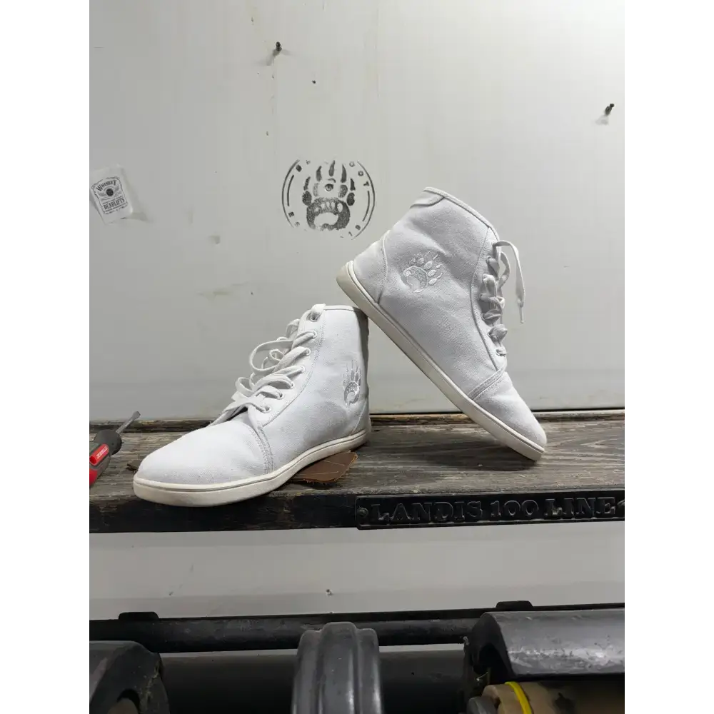 White high-top canvas sneakers from Barely Used Footwear with paw print logo