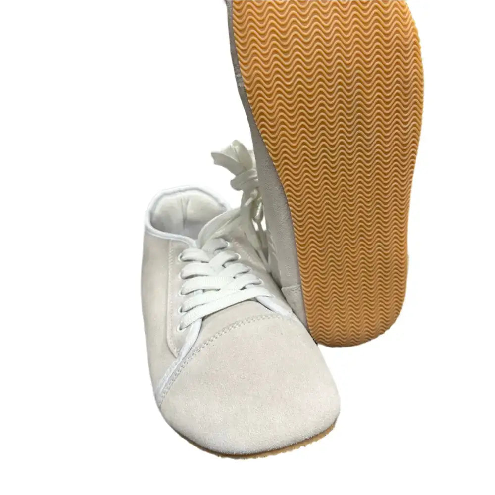 White suede lace-up footwear from Bearly Used with tan wavy sole, minor imperfections