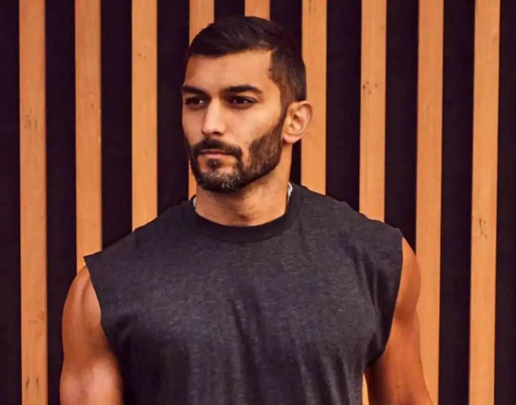 Charcoal gray sleeveless tank top with ribbed neckline and textured fabric.