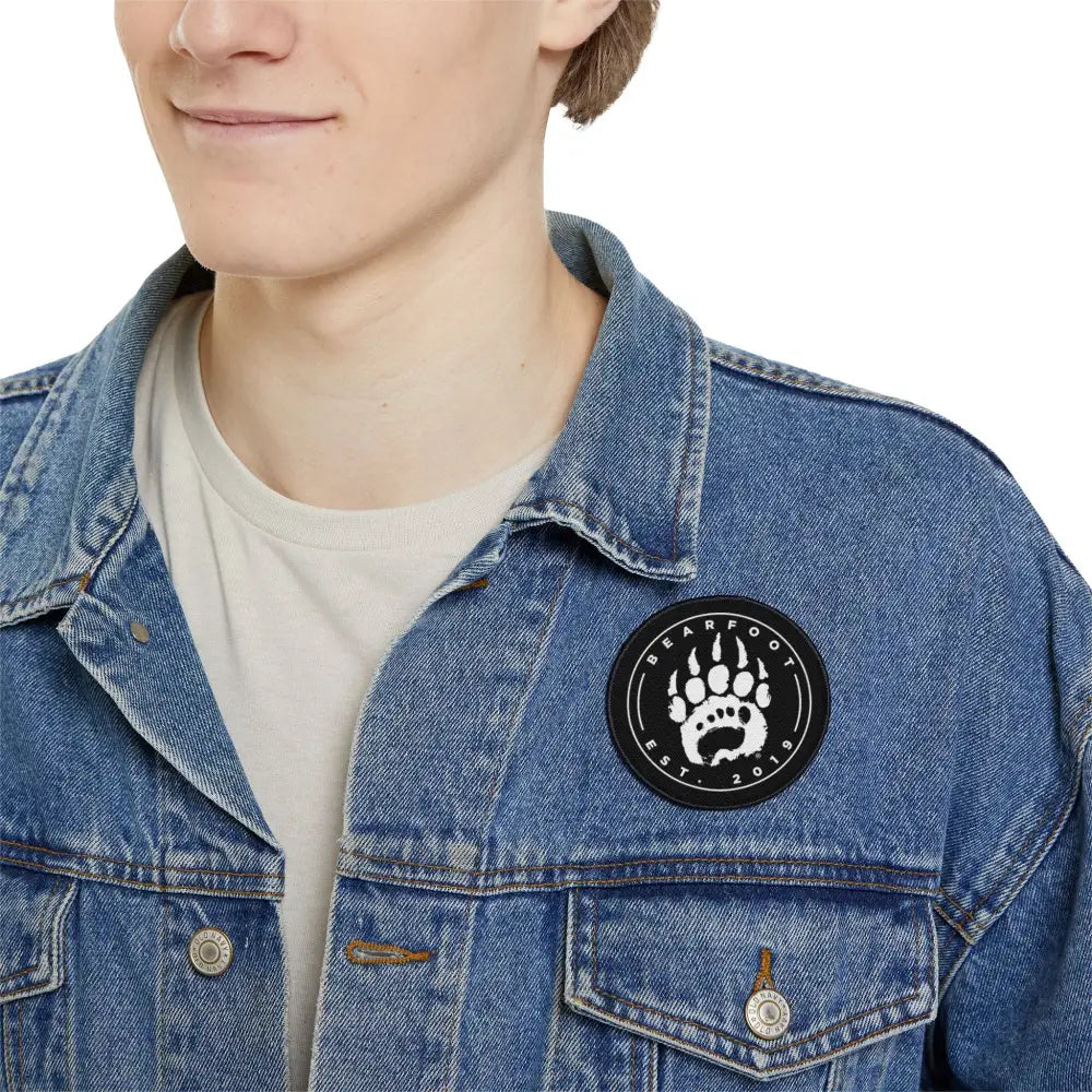 Black bear paw iron-on patch on denim jacket