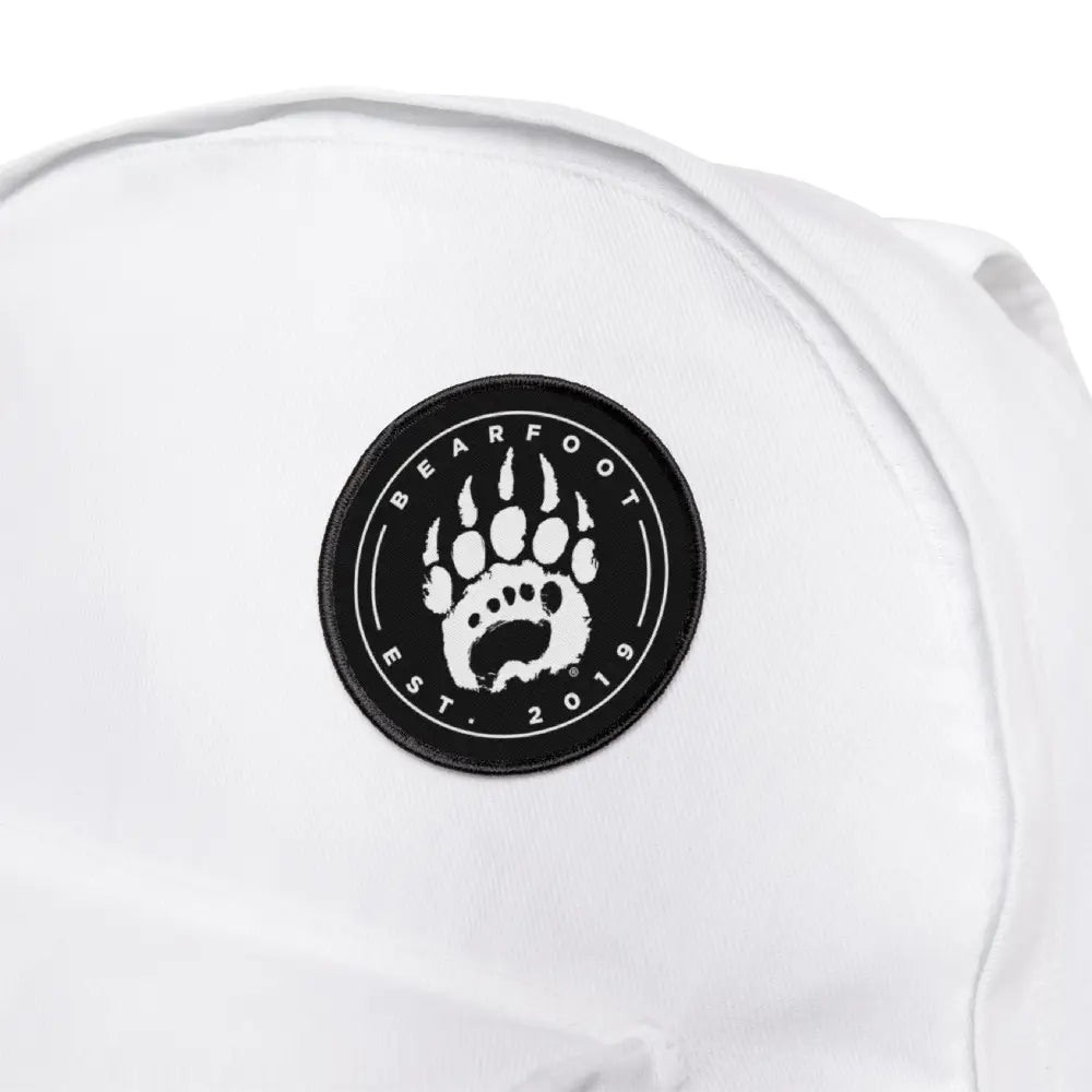 White bearfoot logo iron-on patch on backpack