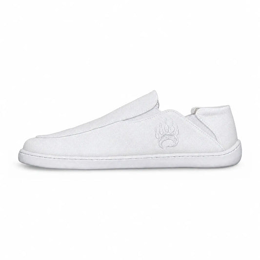 White canvas barefoot slip-on shoe oso cg2 with wide toe box and subtle embroidered paw print logo on the side