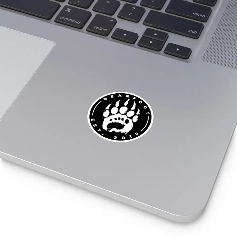Black and white round stickers featuring a bear paw print and bearfoot est text with protective laminate in round shape