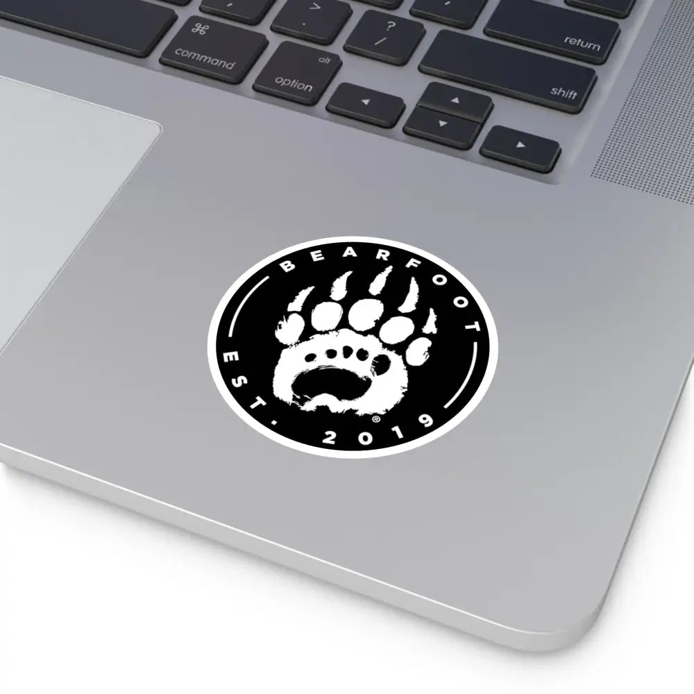 Black and white round stickers with a bear paw print and bearfoot est text featuring protective laminate and round shape