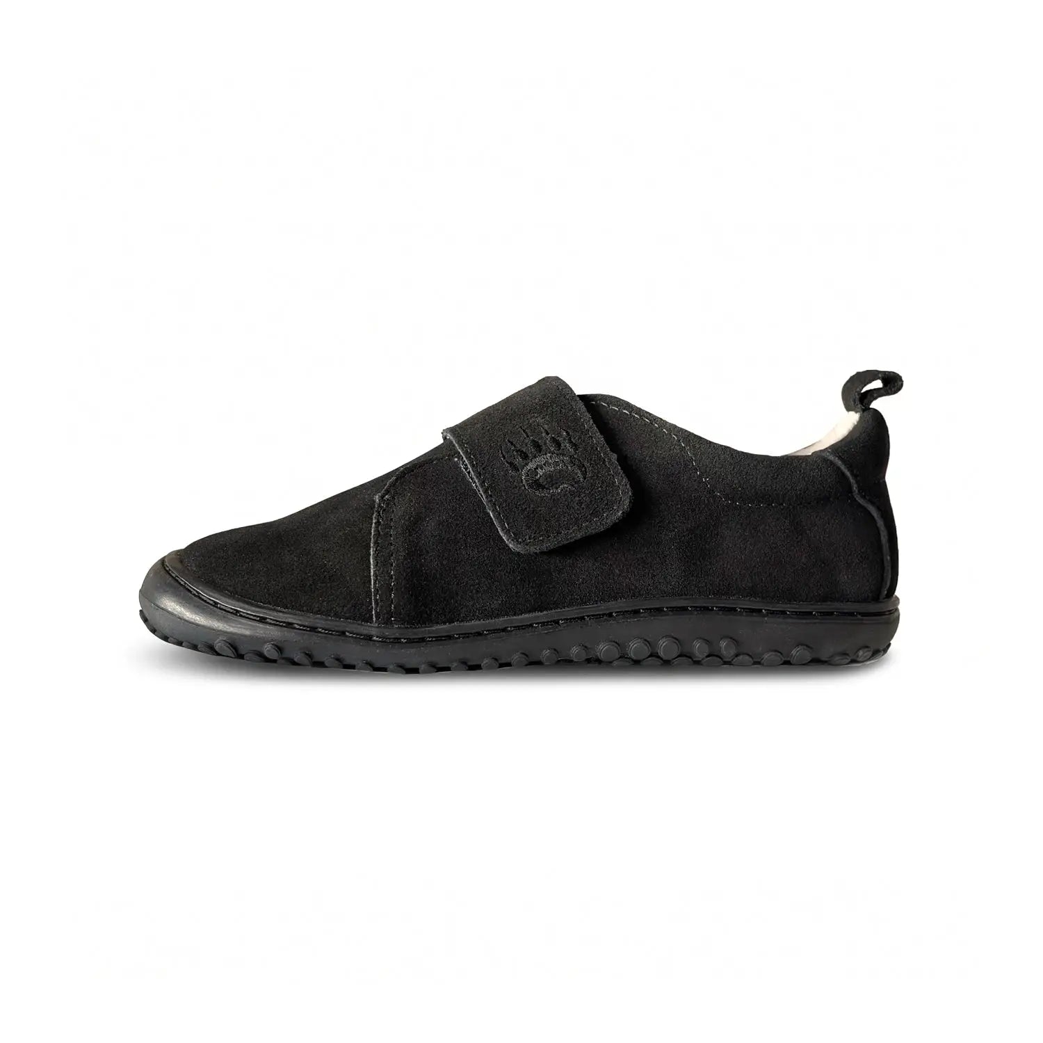Ursa black suede slip-on shoe with velcro strap and paw print logo featuring a wide toe box for comfort