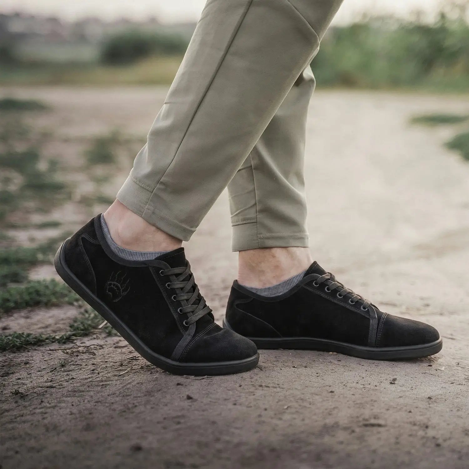 Ursus SLTG2 black suede low-top barefoot shoe with dark laces and subtle embroidered logo for natural toe splay